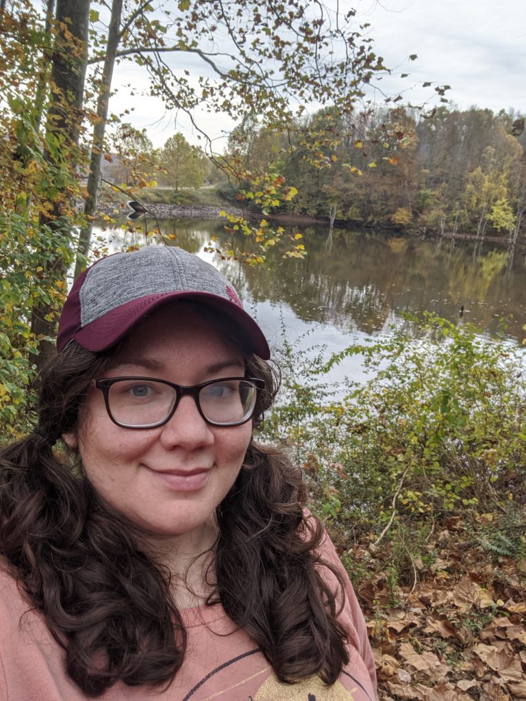 Picture is of writer in front of a lake.
